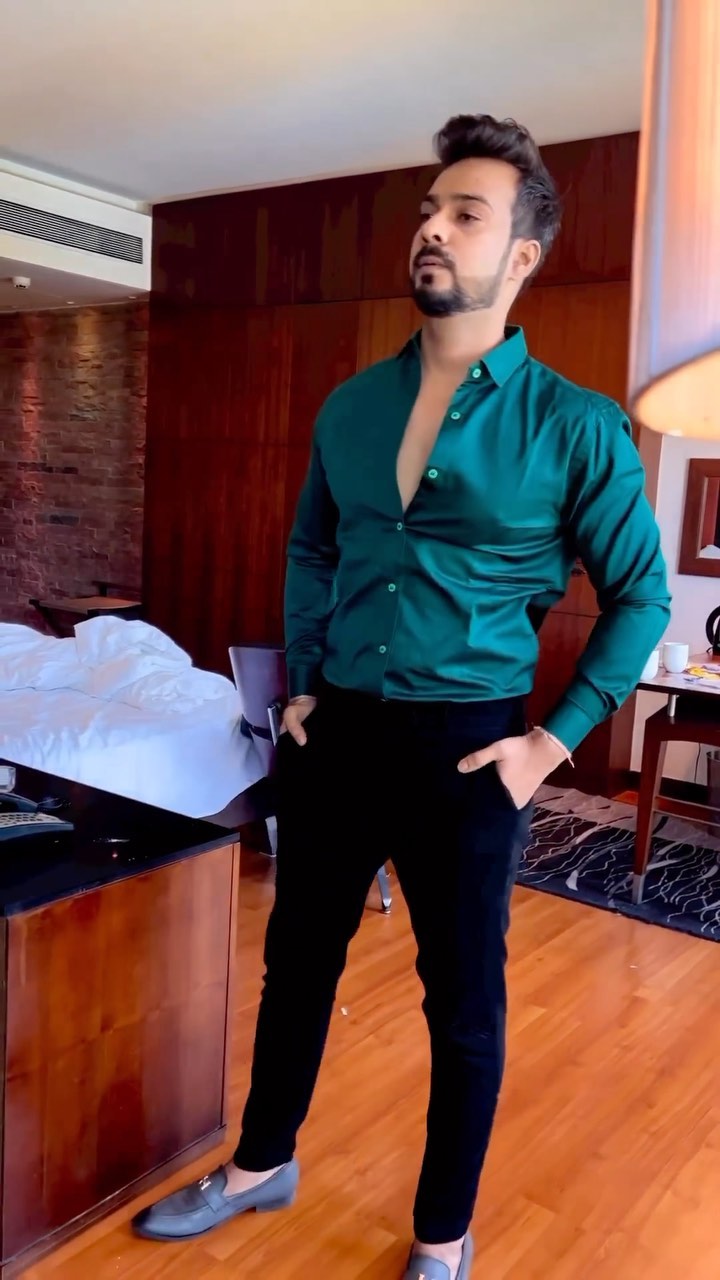 Man wearing an emerald green shirt with black tailored trousers and grey suede loafers
