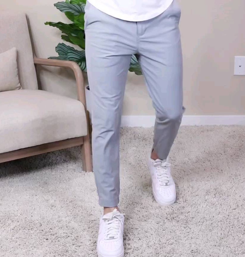 Light-grey tapered trousers finishing cleanly above white low-top casual sneakers