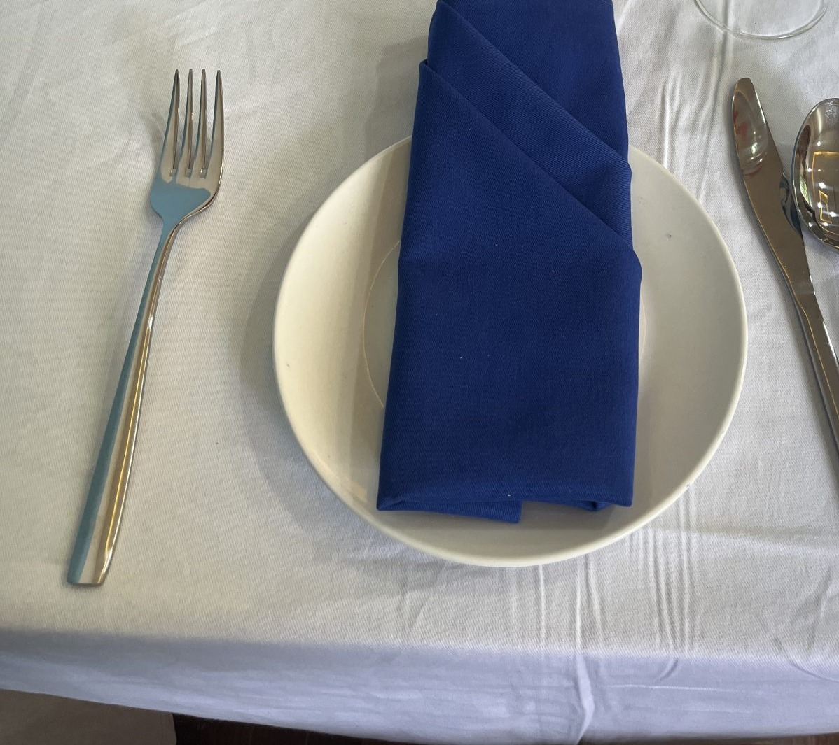 Plate, fork, knife and spoon in a simple place setting
