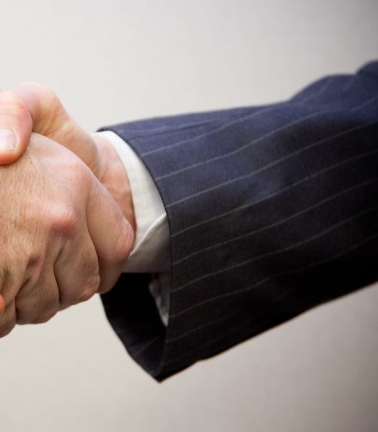 Opposing suit sleeve and cuff at the point of a professional handshake