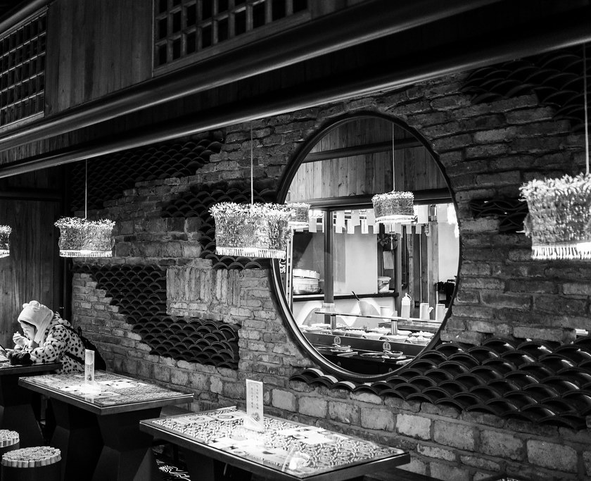 Black-and-white dining room detail illustrating awareness of other people in a shared space