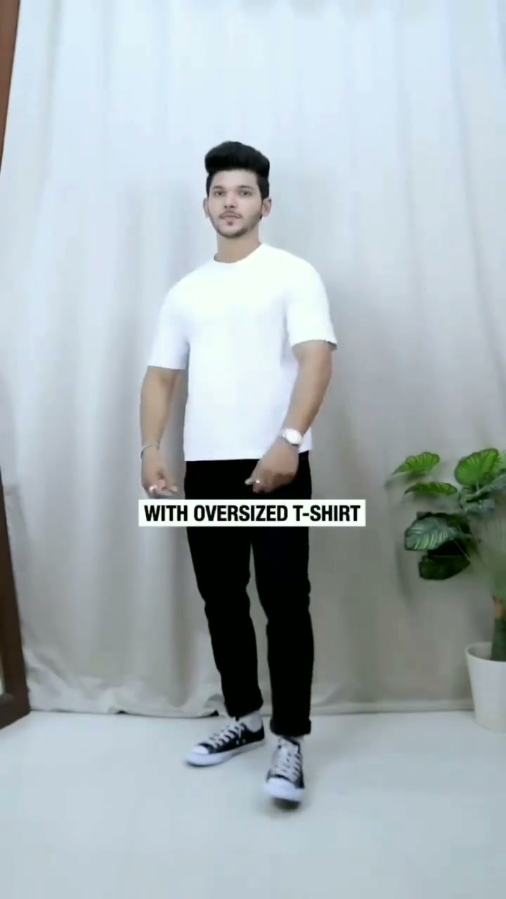 Oversized white T-shirt with black jeans and black-and-white canvas sneakers
