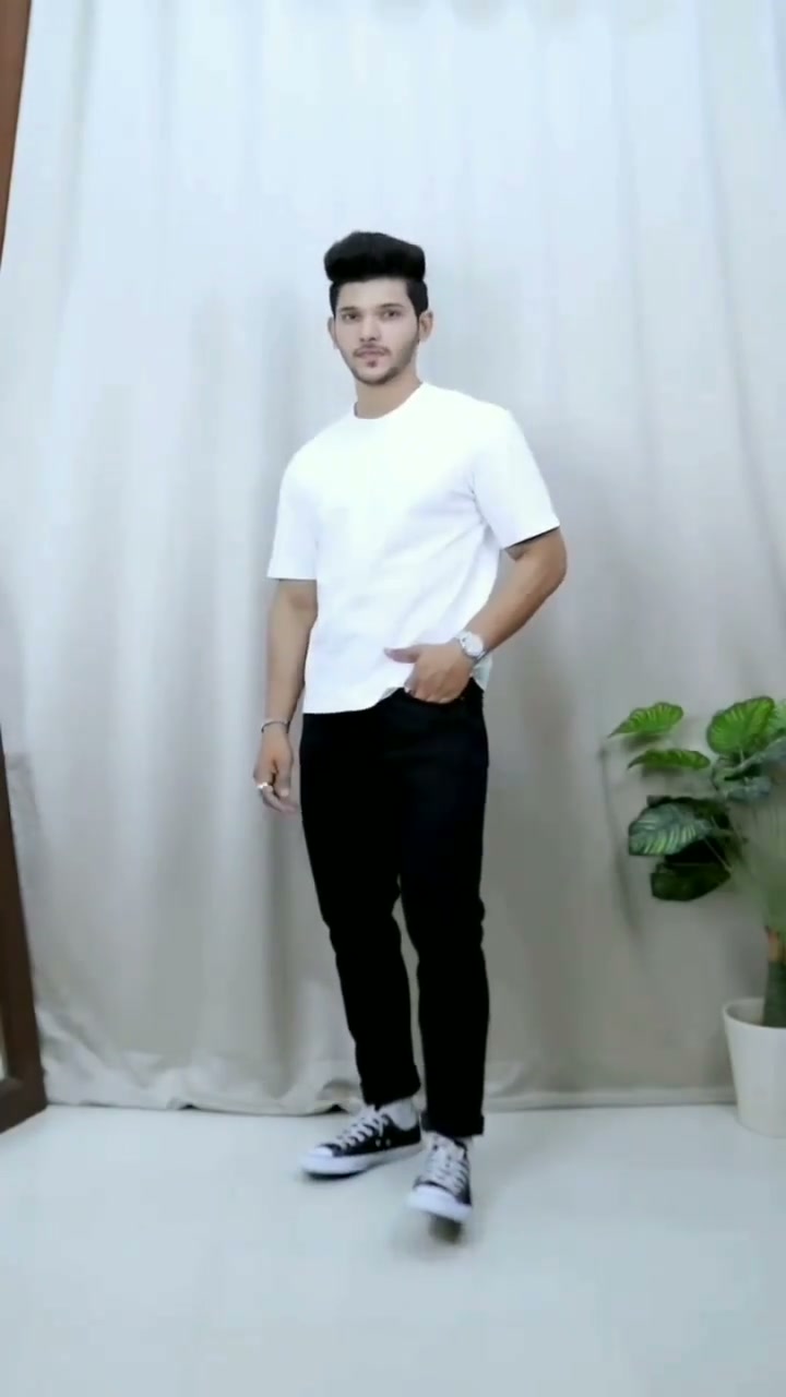 Simple white T-shirt with black jeans and canvas sneakers