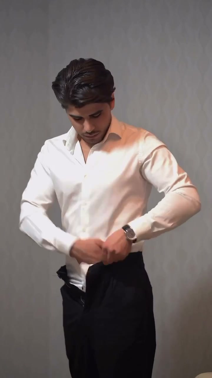 Fastening the trouser waistband over the folded shirt fabric