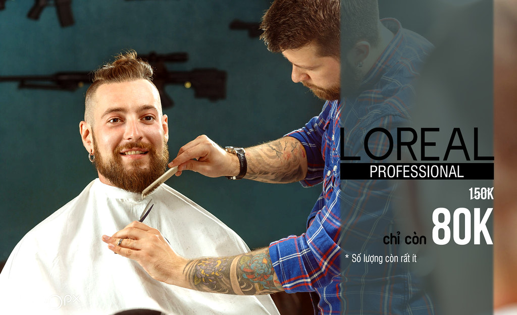 Close-up of a barber shaving a client's cheek with a straight razor and lather