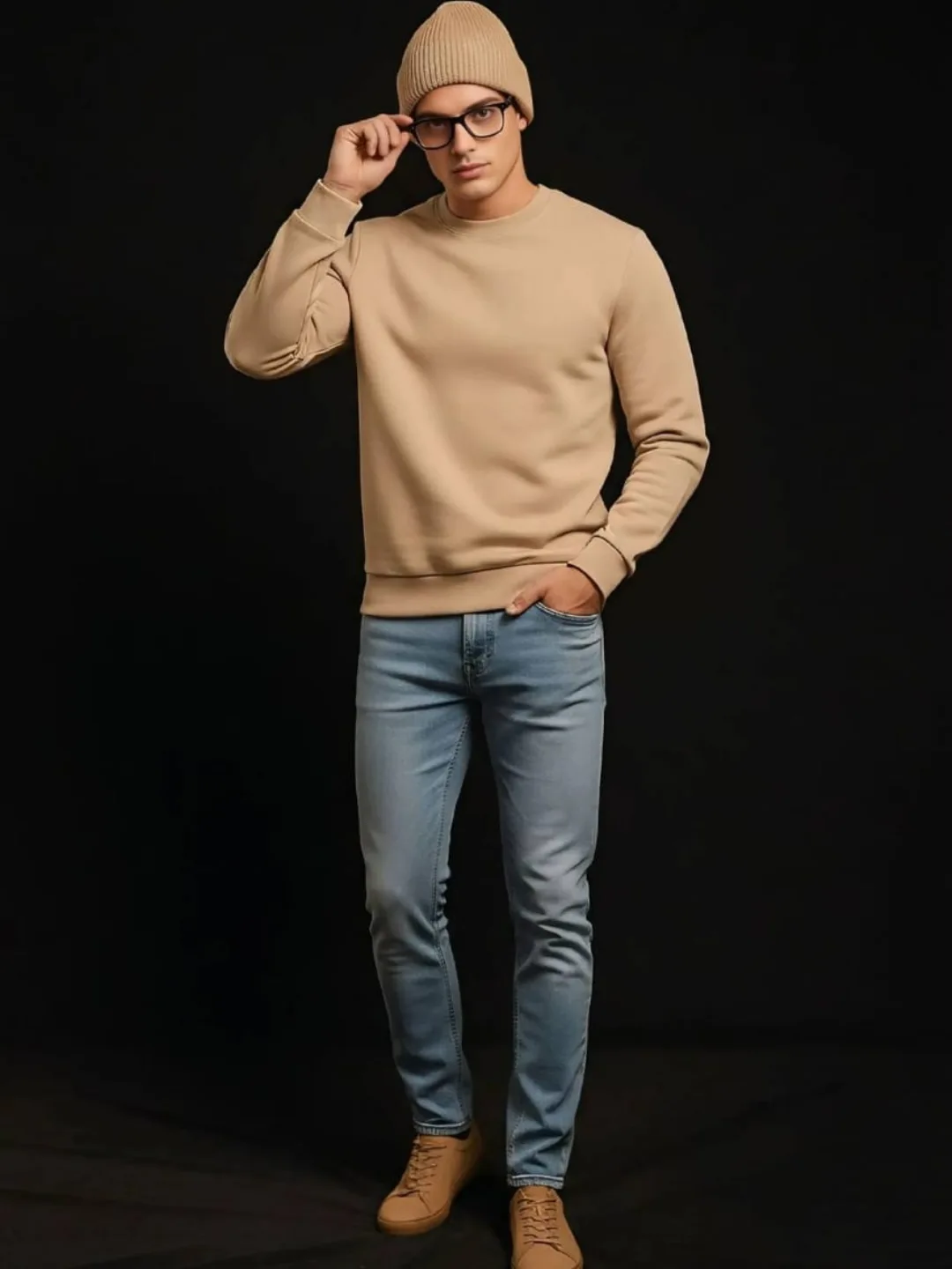 Beige sweatshirt worn with beanie, glasses and light denim