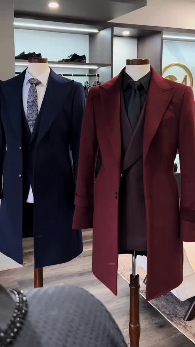 Navy suit with white shirt and patterned tie beside a burgundy formal coat with black shirt and tie