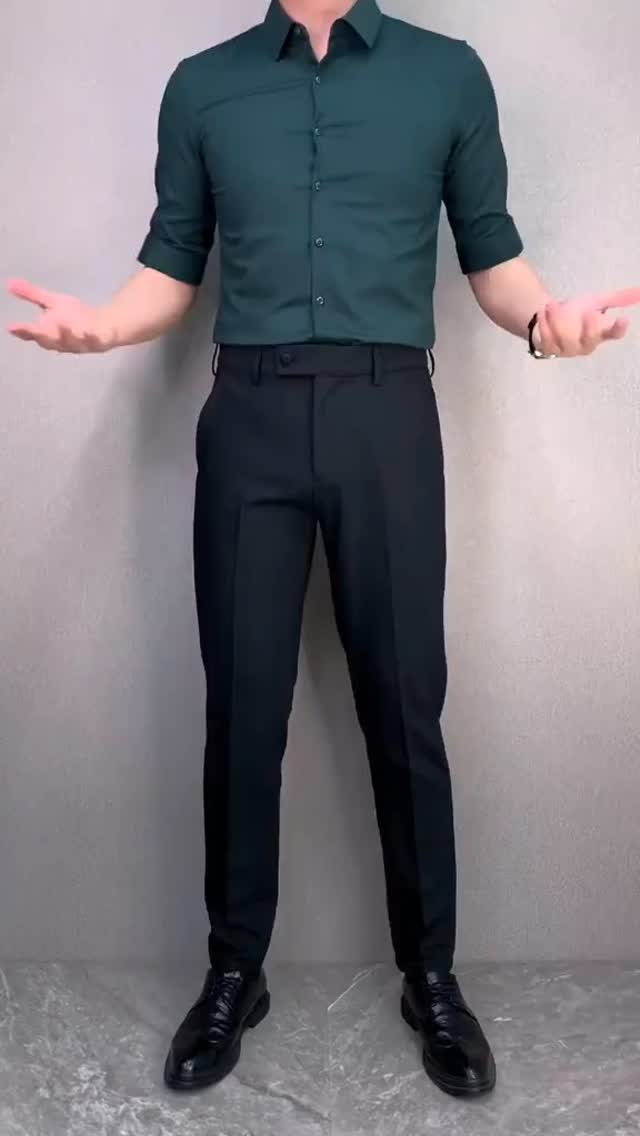 Men's office outfit with a dark green shirt, black tailored trousers, black belt and black dress shoes